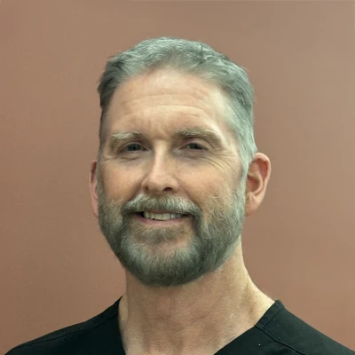 Dr. Patrick Davis DMD featured in a portrait showcasing his biography on the Davis Dental team page